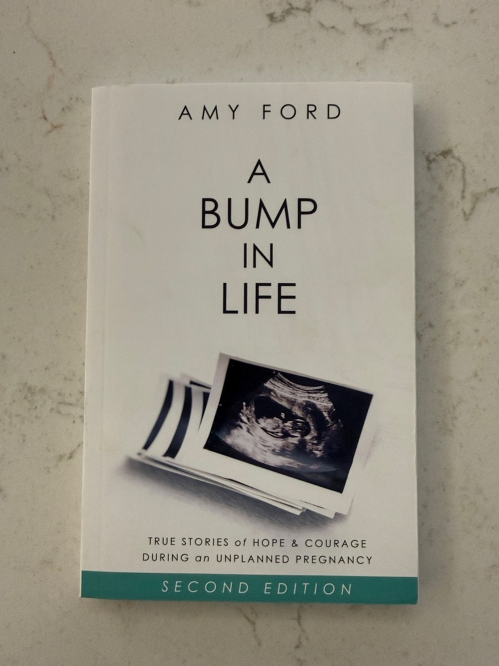 Amy Ford "A Bump in Life" Paperback Book - White with Teal Accent